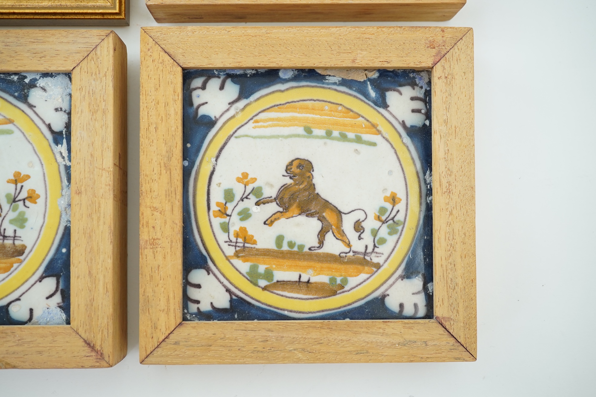 Three Spanish polychrome maiolica ‘animal’ tiles, Triana, early 18th century and a Delft blue and white tile, 19th century